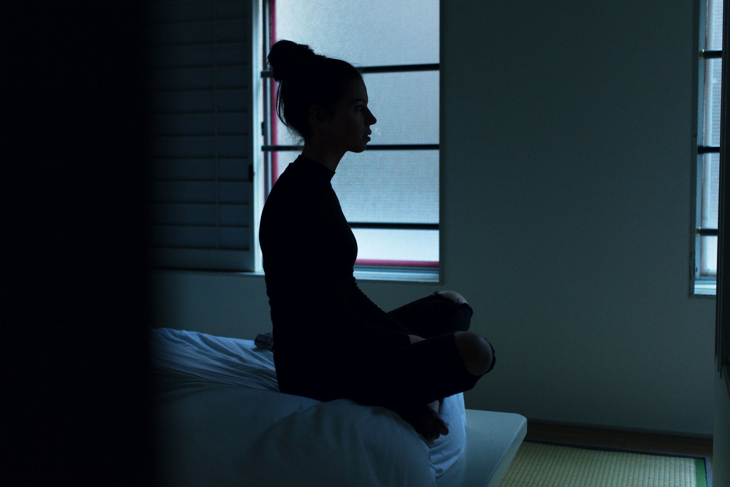 woman sitting on bed